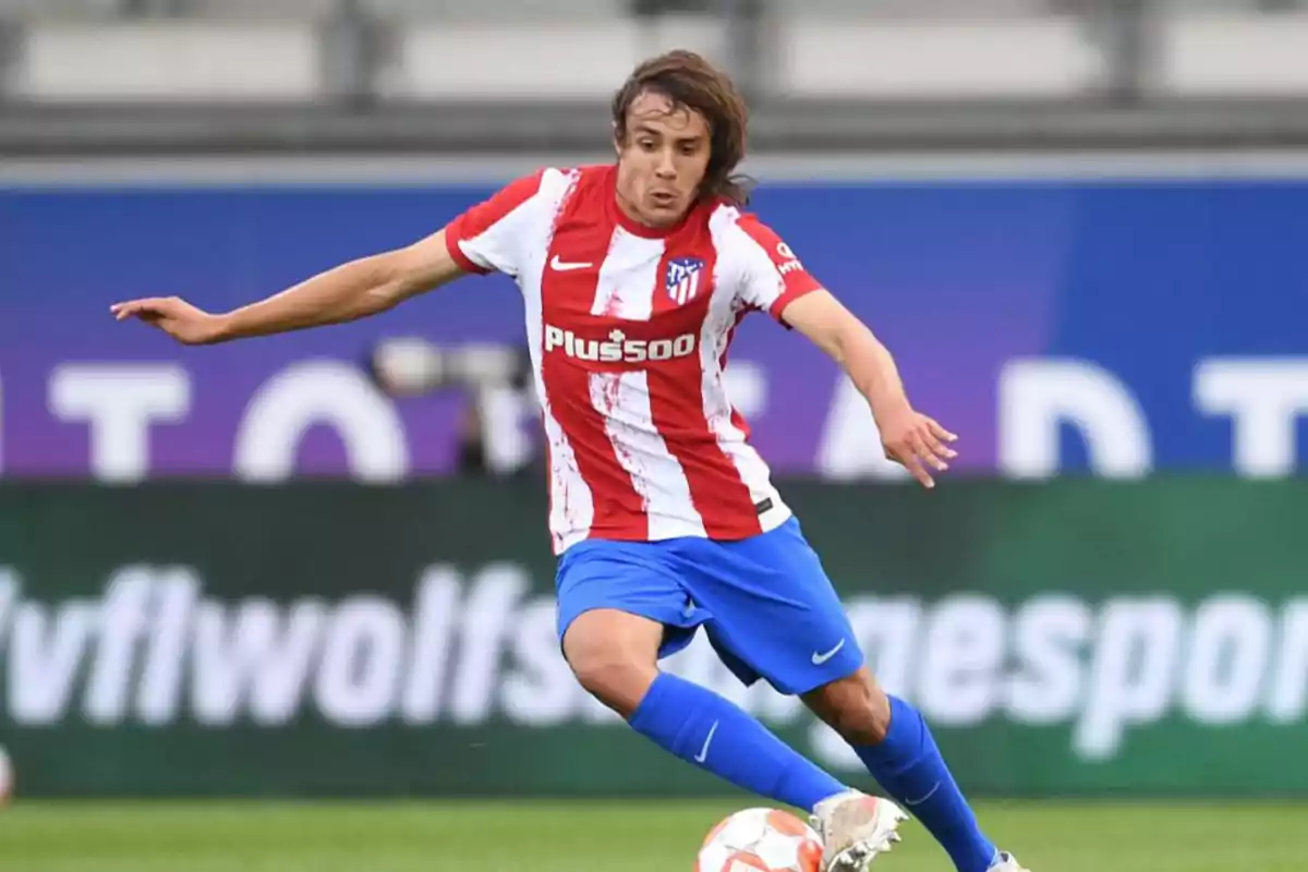 Football player in Atletico Madrid uniform in action during a match