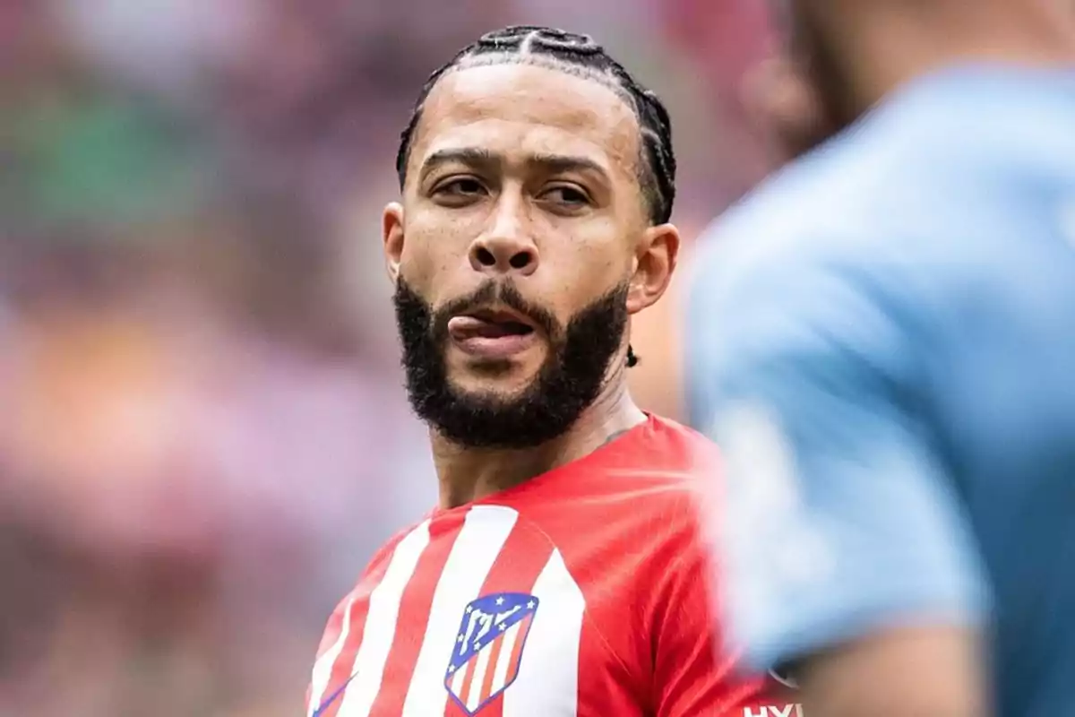 Soccer player with an Atlético de Madrid shirt on the playing field.