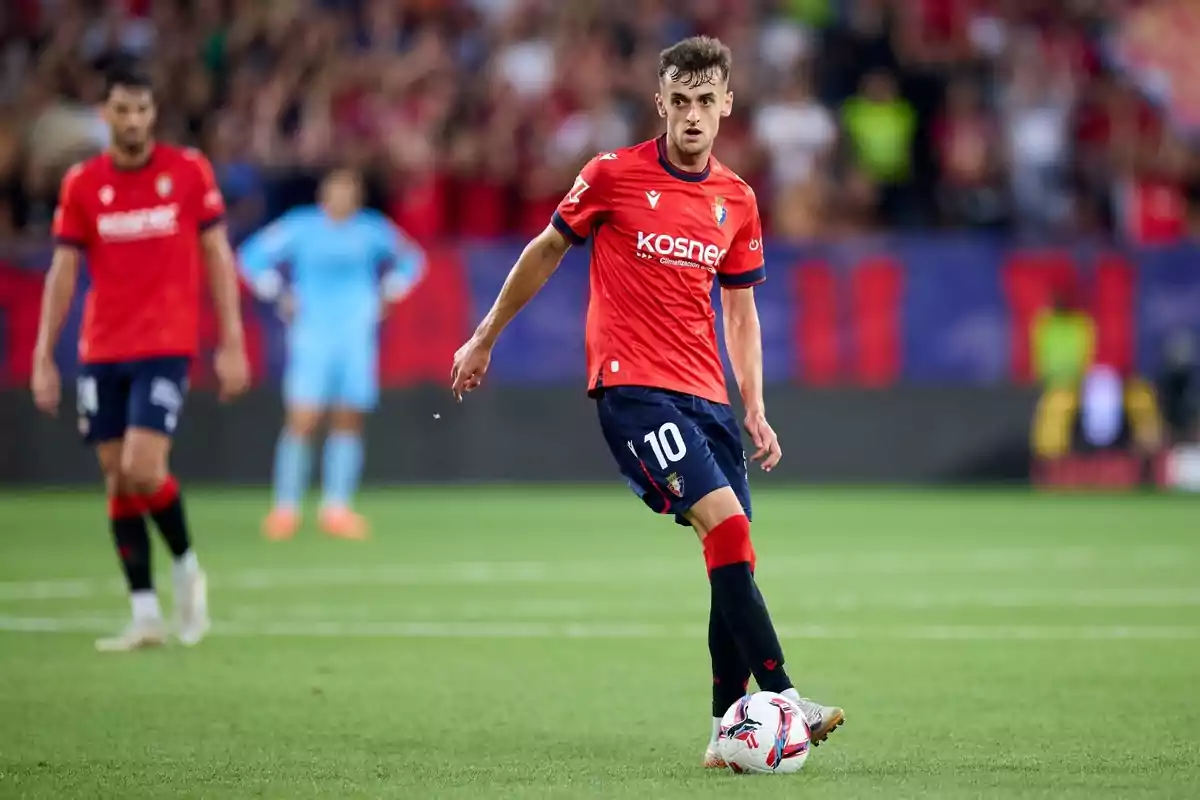 Soccer player with red jersey and number 10 on the playing field.