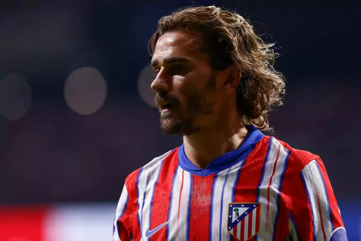 Football player wearing an Atlético de Madrid shirt in a stadium.