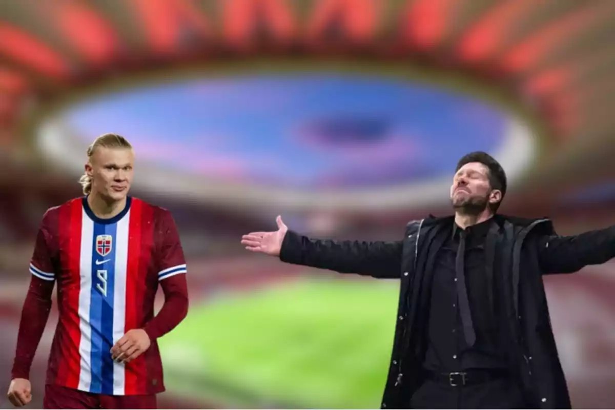 A football player in a red and blue uniform stands next to a man in a black suit in a stadium.