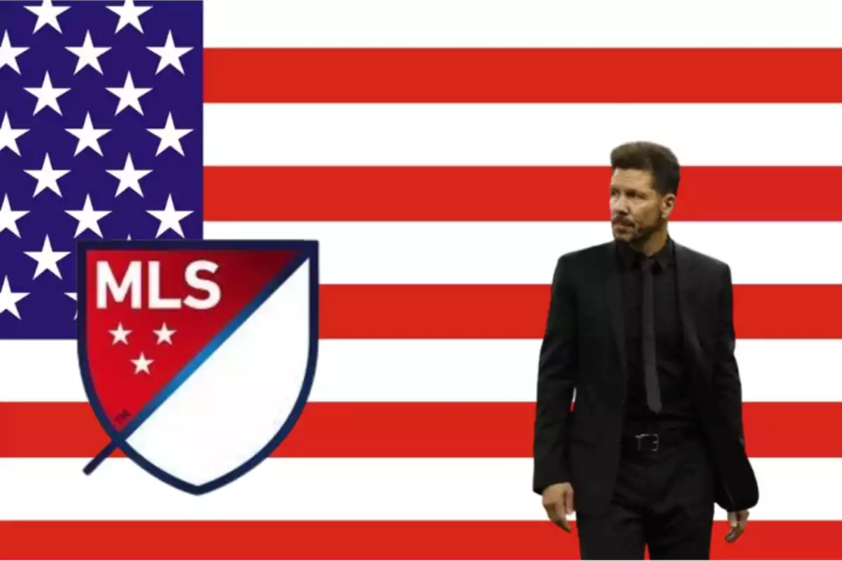 Man in black suit next to MLS logo on American flag.