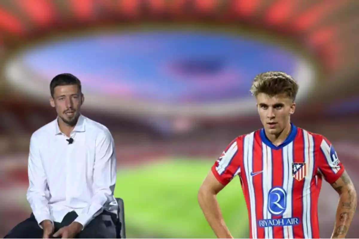 Two men, one sitting in a white shirt and the other standing in an Atlético de Madrid football uniform, with an out-of-focus stadium in the background.