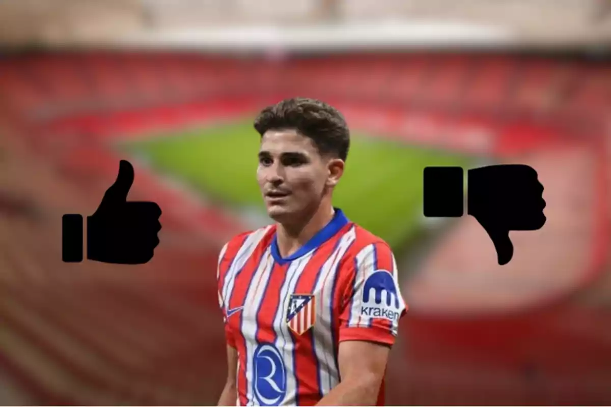 A football player wearing an Atlético de Madrid shirt, with a thumbs up on the left and a thumbs down on the right, in an out-of-focus stadium.