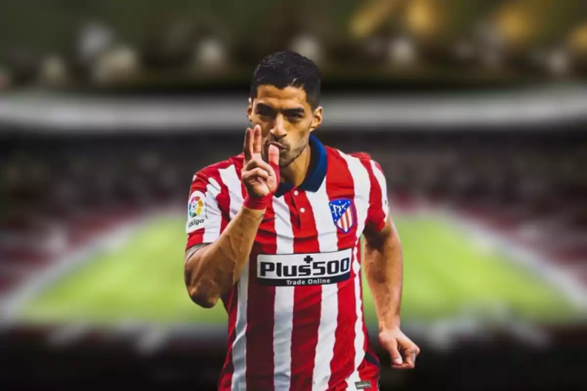 Football player in Atlético de Madrid uniform celebrating in a stadium.