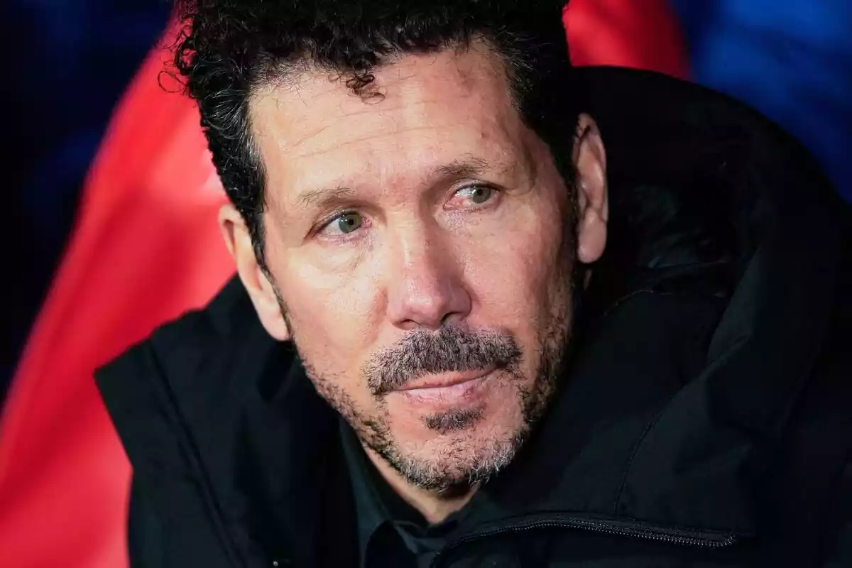 Simeone sitting on the bench looking to the side