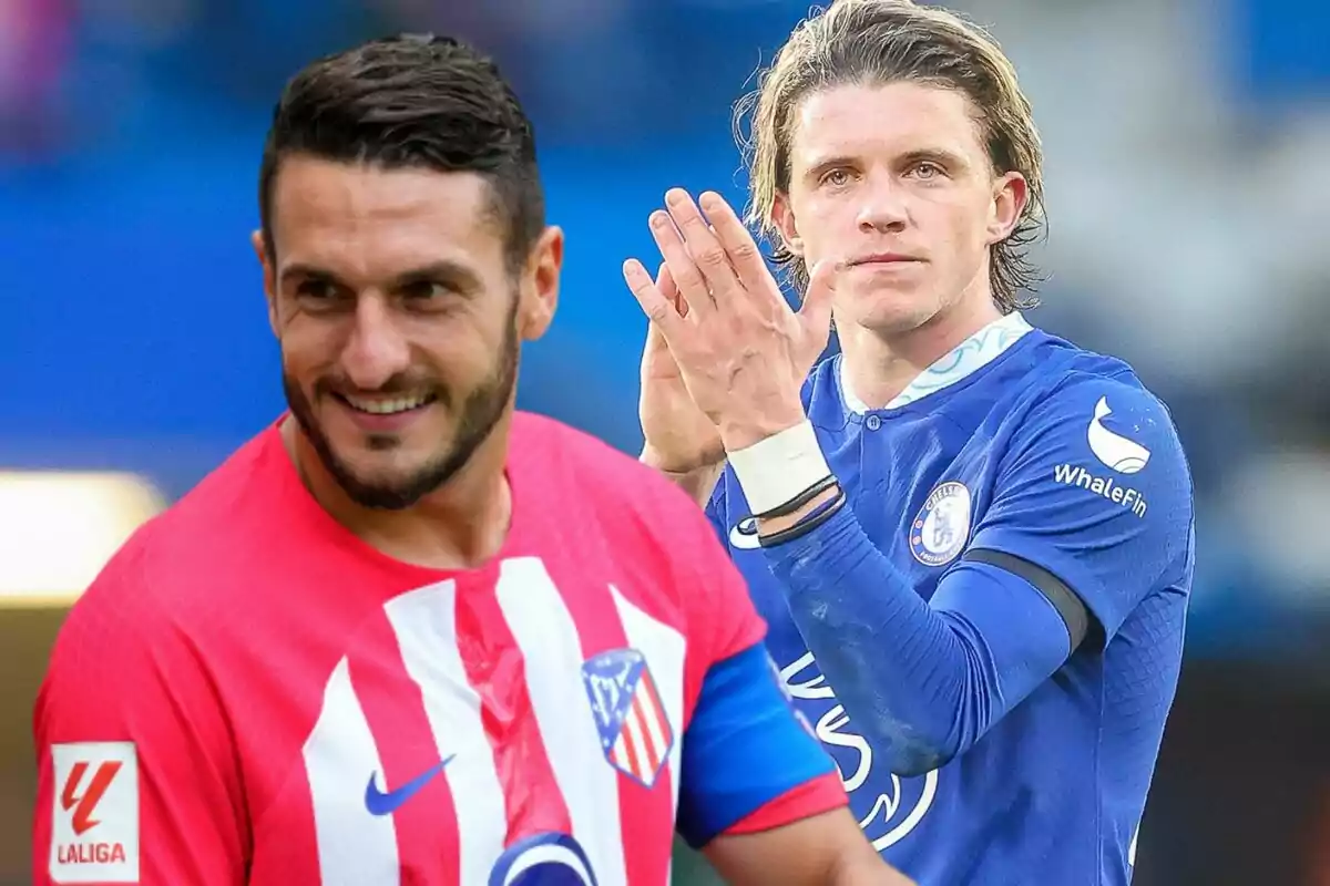 Two football players, one wearing an Atlético de Madrid uniform and the other wearing a Chelsea uniform, on a playing field.