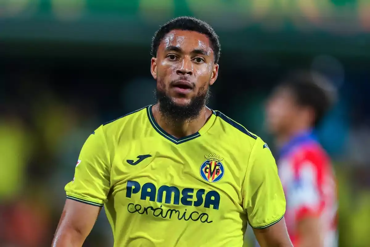 A football player wearing the yellow shirt of Villarreal CF on the pitch.