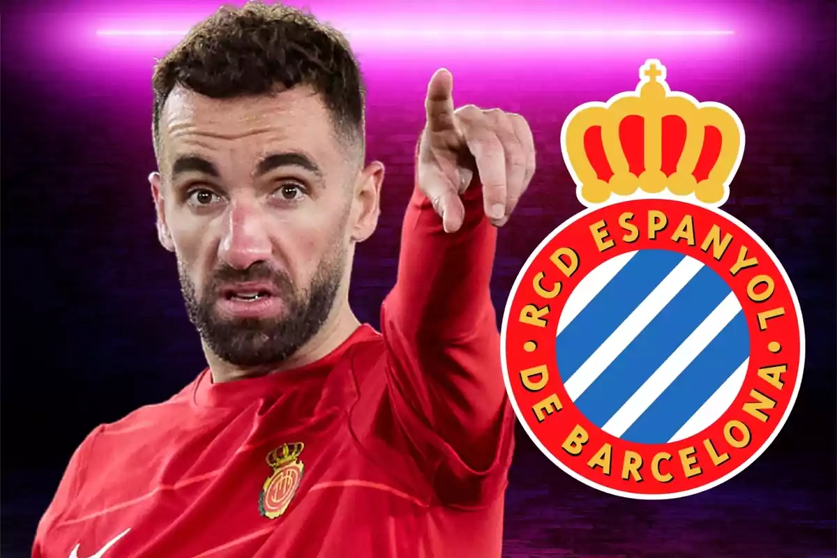 A football player in a red uniform points forward, with the RCD Espanyol de Barcelona crest at his side.