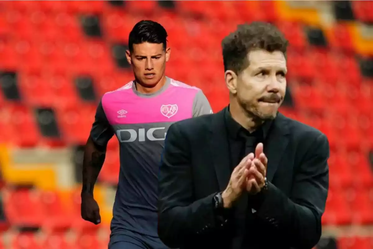 A football player in a grey and pink Umbro uniform and a coach applauding in a stadium with red seats.