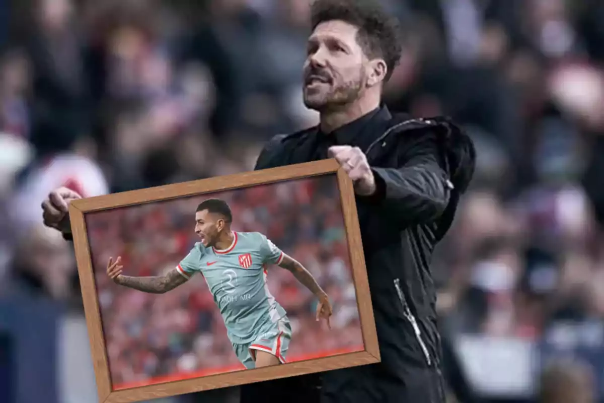 A man holds a wooden frame with a picture of a football player on the field.