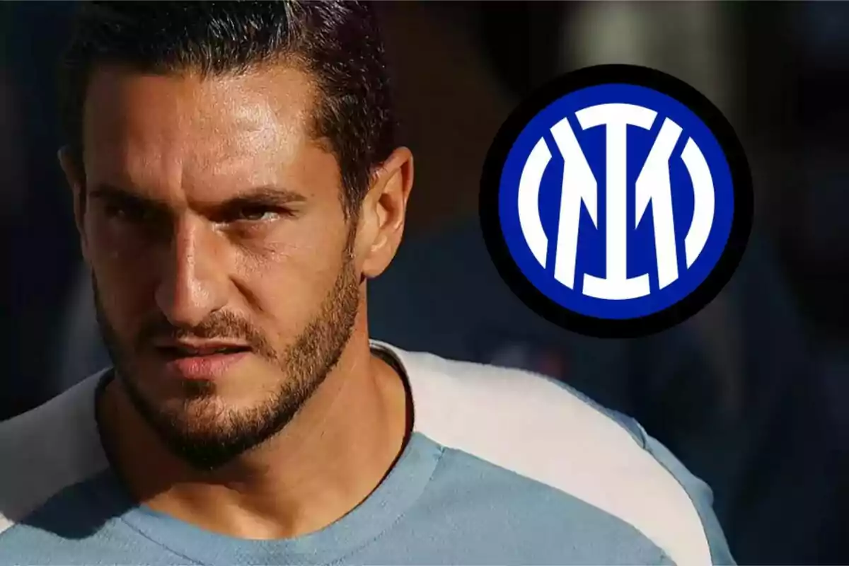 A man with a beard and dark hair, wearing a light blue shirt, with the Inter Milan logo in the background.