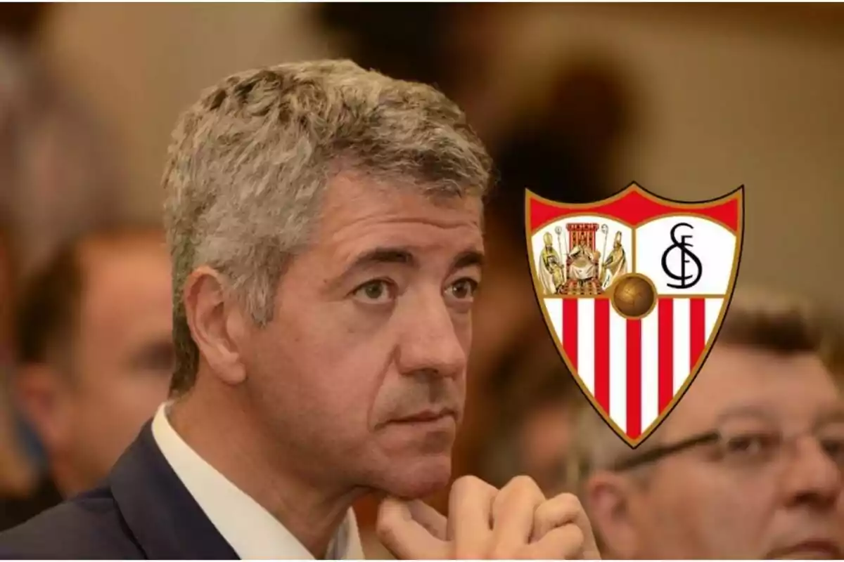 Pensive man with the Sevilla FC shield next to him.