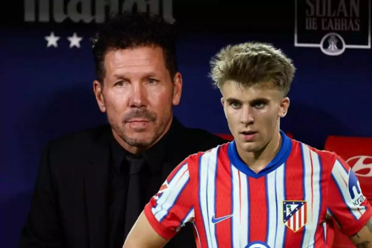 Two men, one in a black suit and the other in an Atlético de Madrid football uniform, pose for a photo.