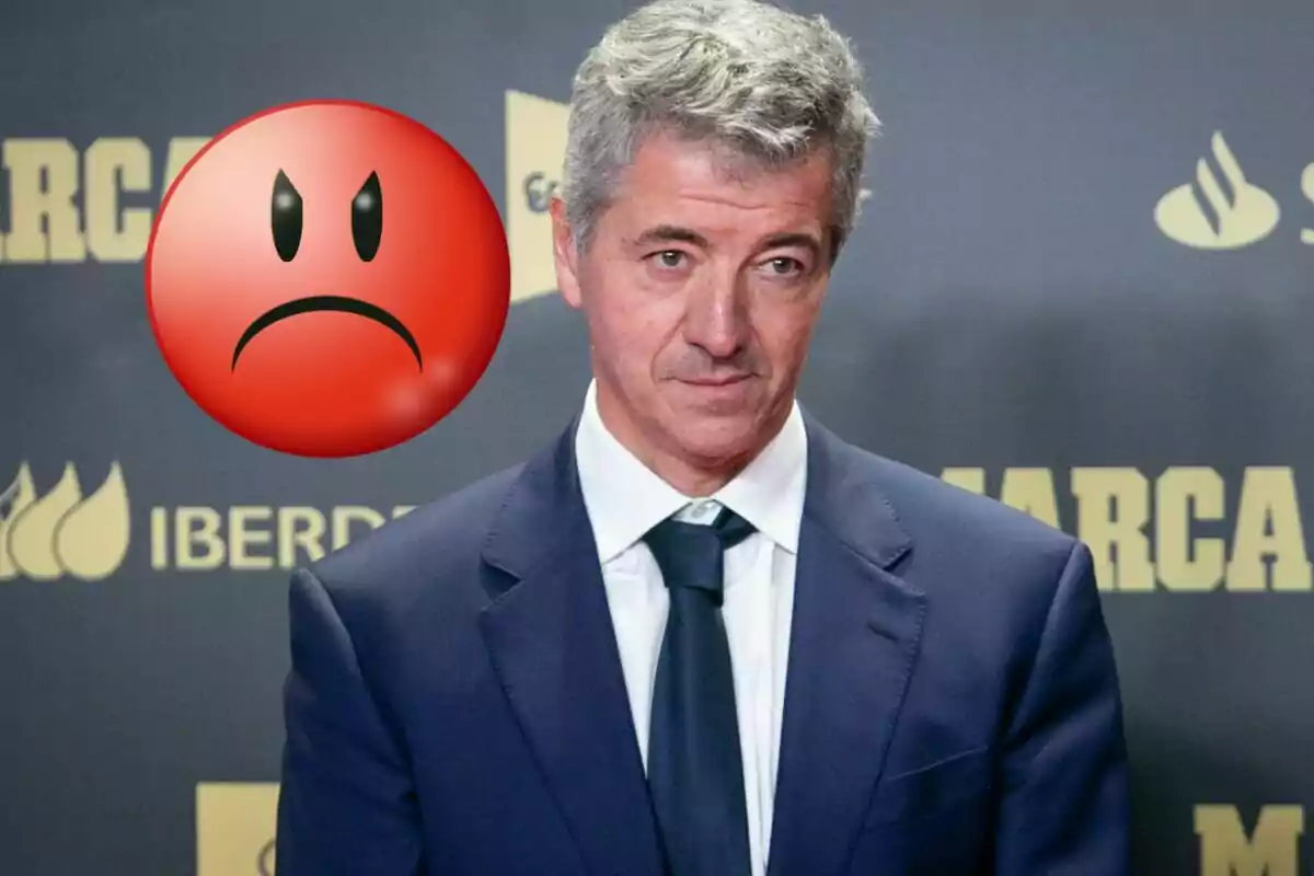 Man in suit with angry face emoji next to him.