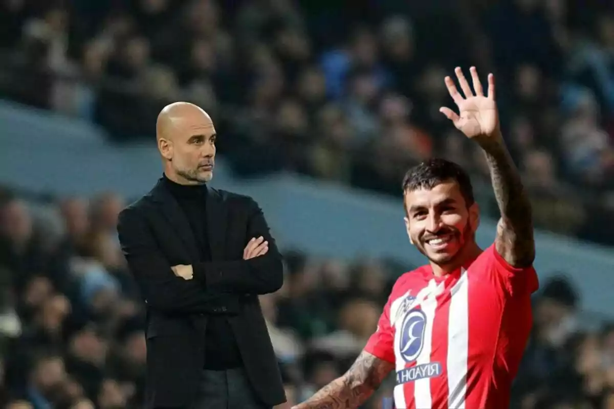 A soccer coach looks on with his arms crossed as a smiling player in a red and white uniform waves to the crowd.