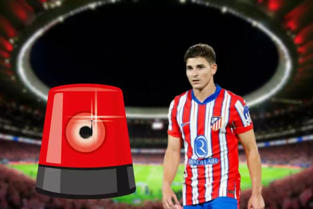 A football player in an Atletico Madrid uniform in a stadium with a red siren superimposed on the image.