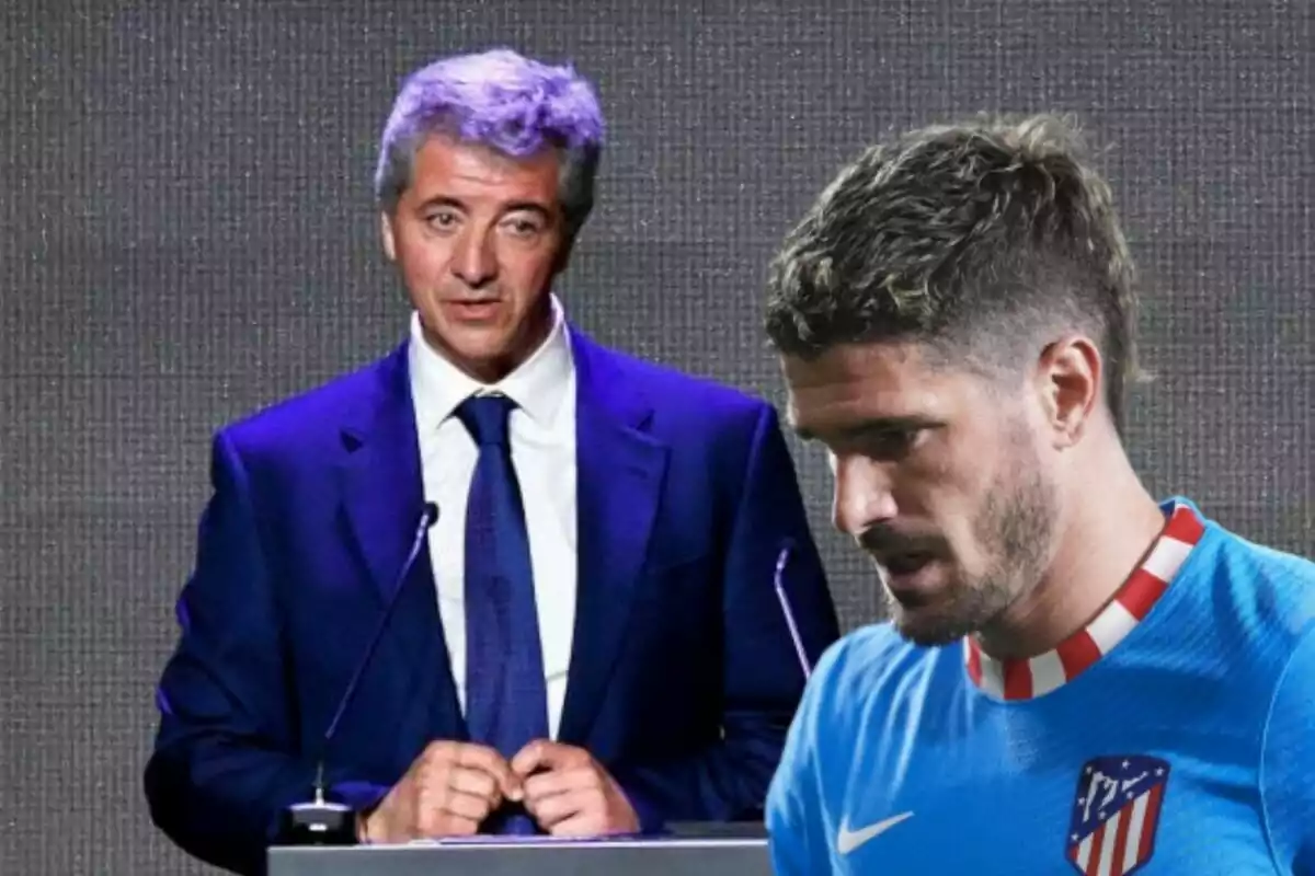 A man in a suit speaking at a podium next to a football player in a blue uniform.