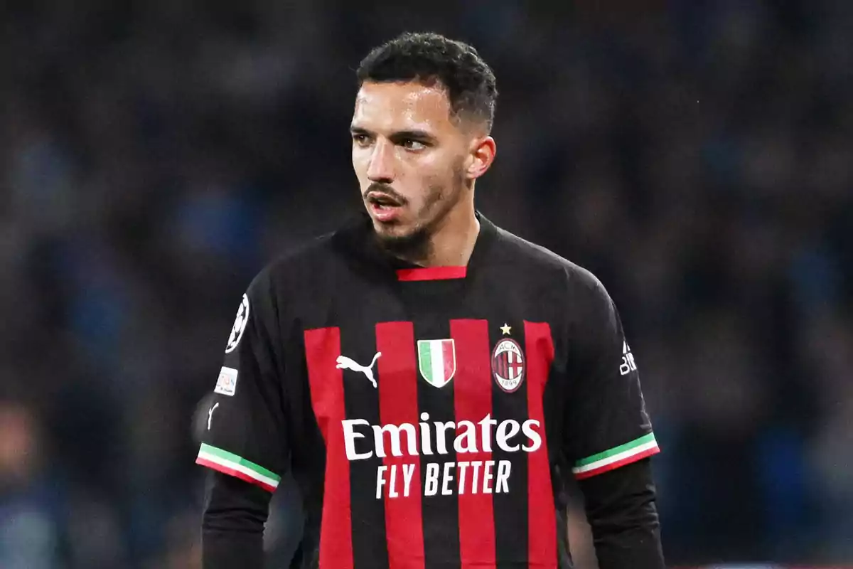 Football player wearing AC Milan shirt on the playing field.