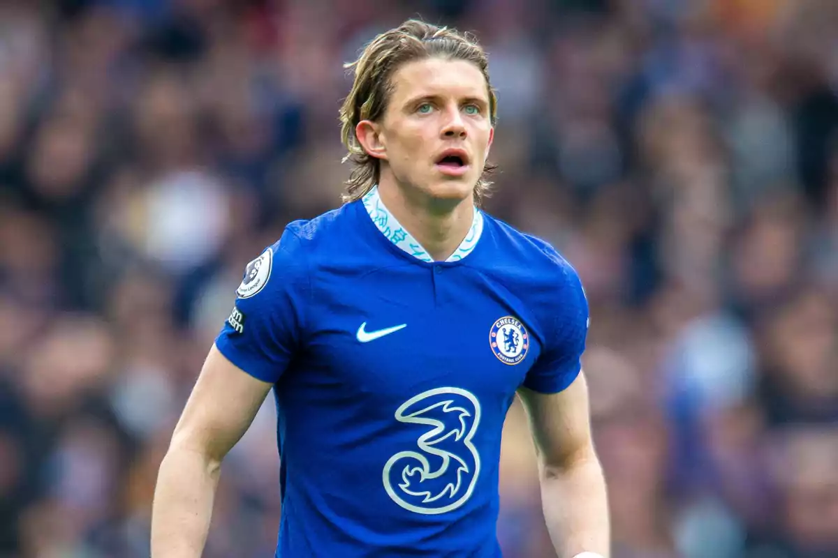 Soccer player in blue Chelsea FC uniform on the playing field.