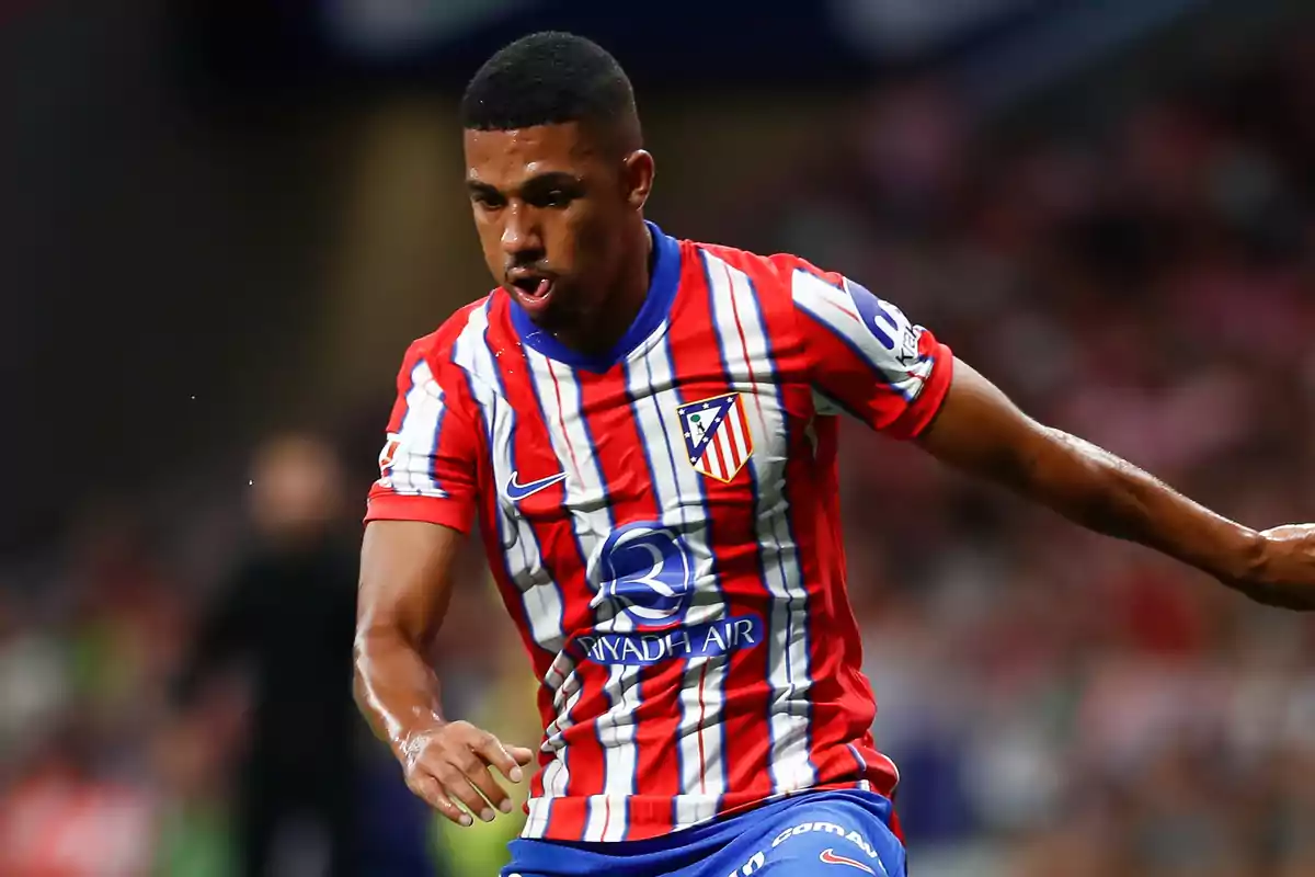 Football player in Atlético de Madrid uniform in action during a match.