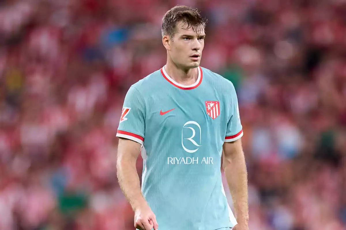 Football player in light blue uniform of Atlético de Madrid on the playing field.