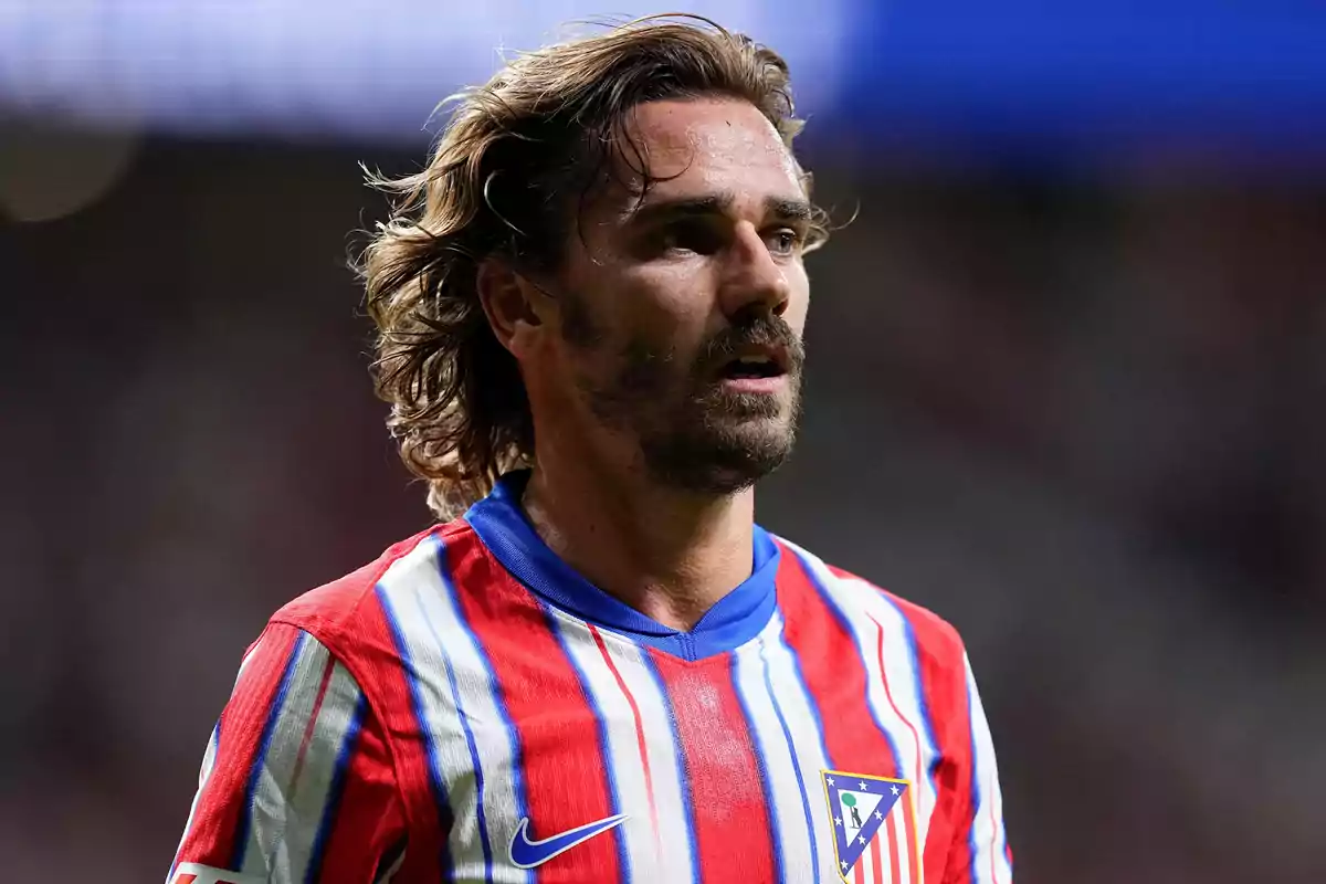 Football player wearing Atlético de Madrid shirt on the playing field.