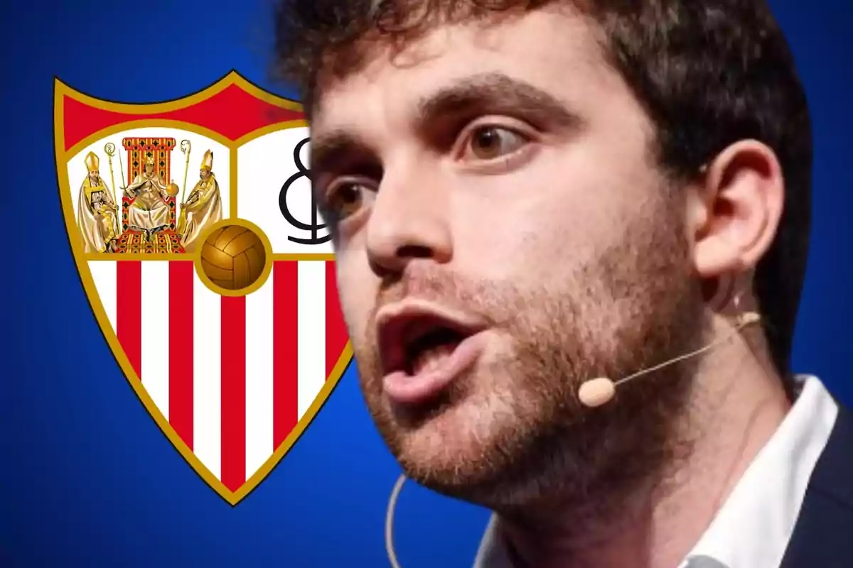 Man speaking with a headset microphone in front of the Sevilla FC shield.