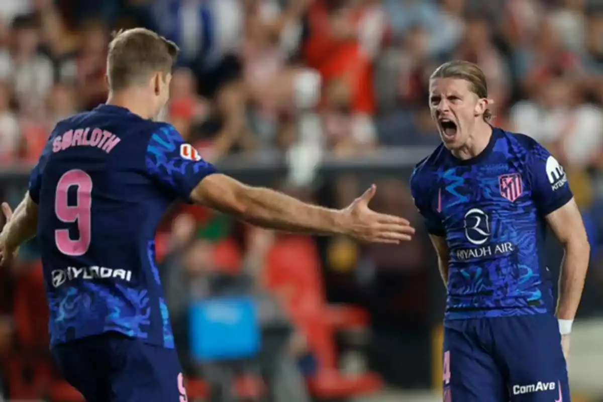 Two football players celebrating a goal, one of them wearing the number 9 jersey and the name "SØRLOTH" on the back.