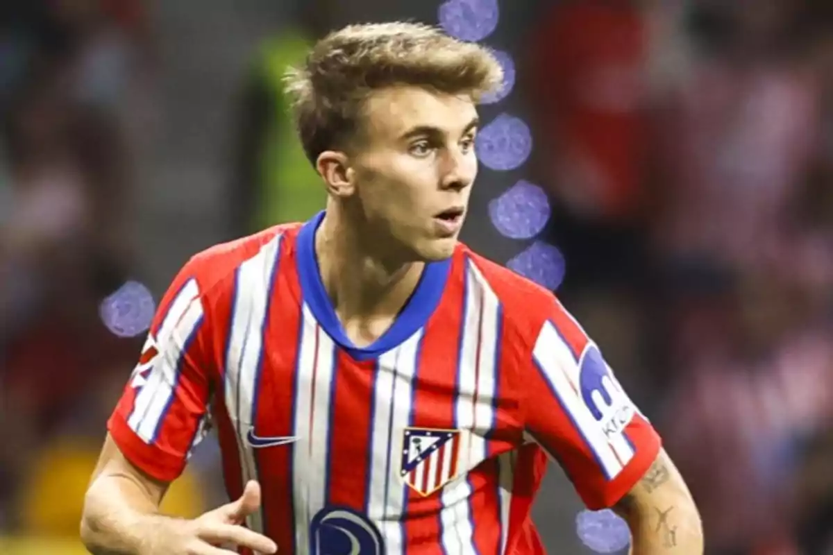 Football player wearing Atlético de Madrid shirt on the playing field.