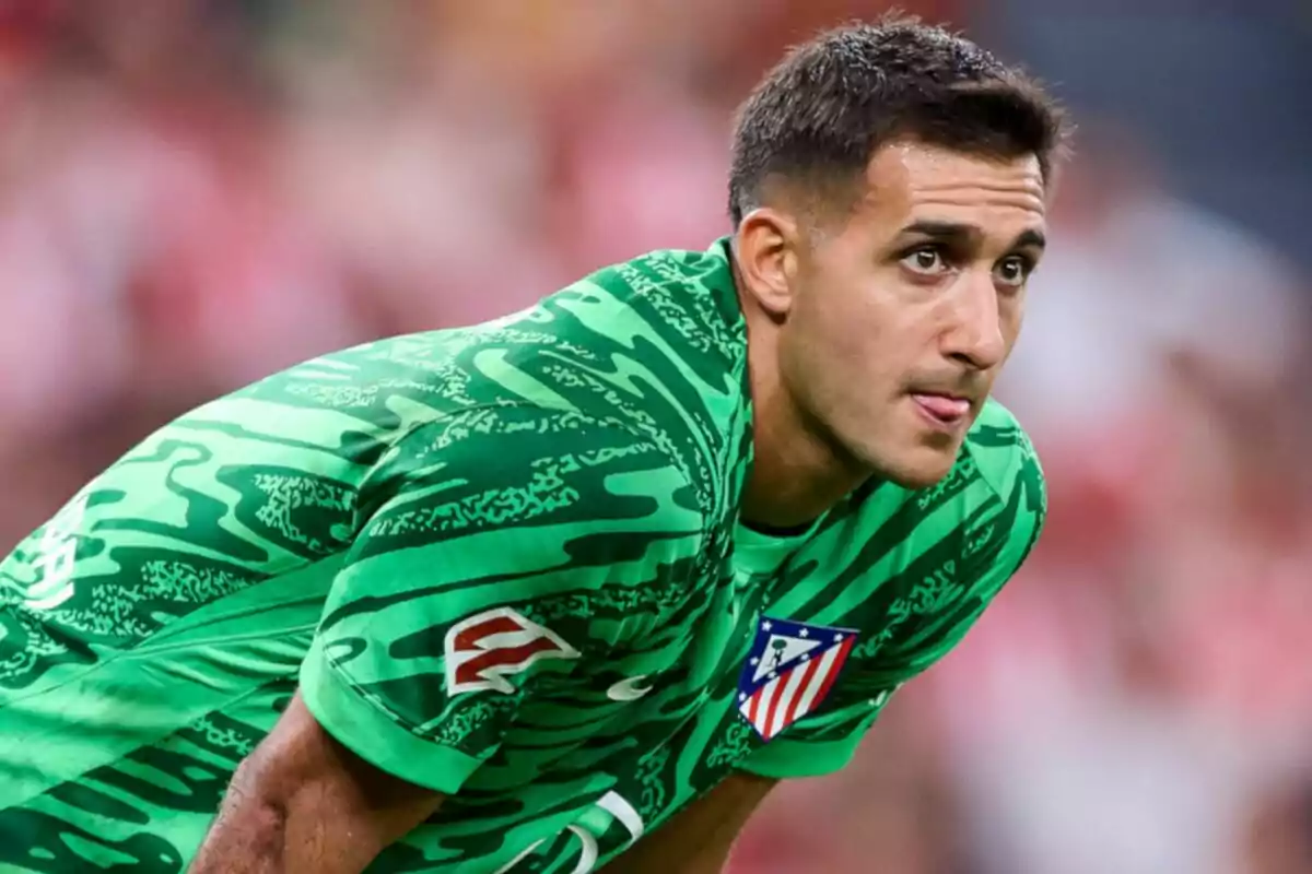 Football player in green Atlético de Madrid uniform on the playing field.