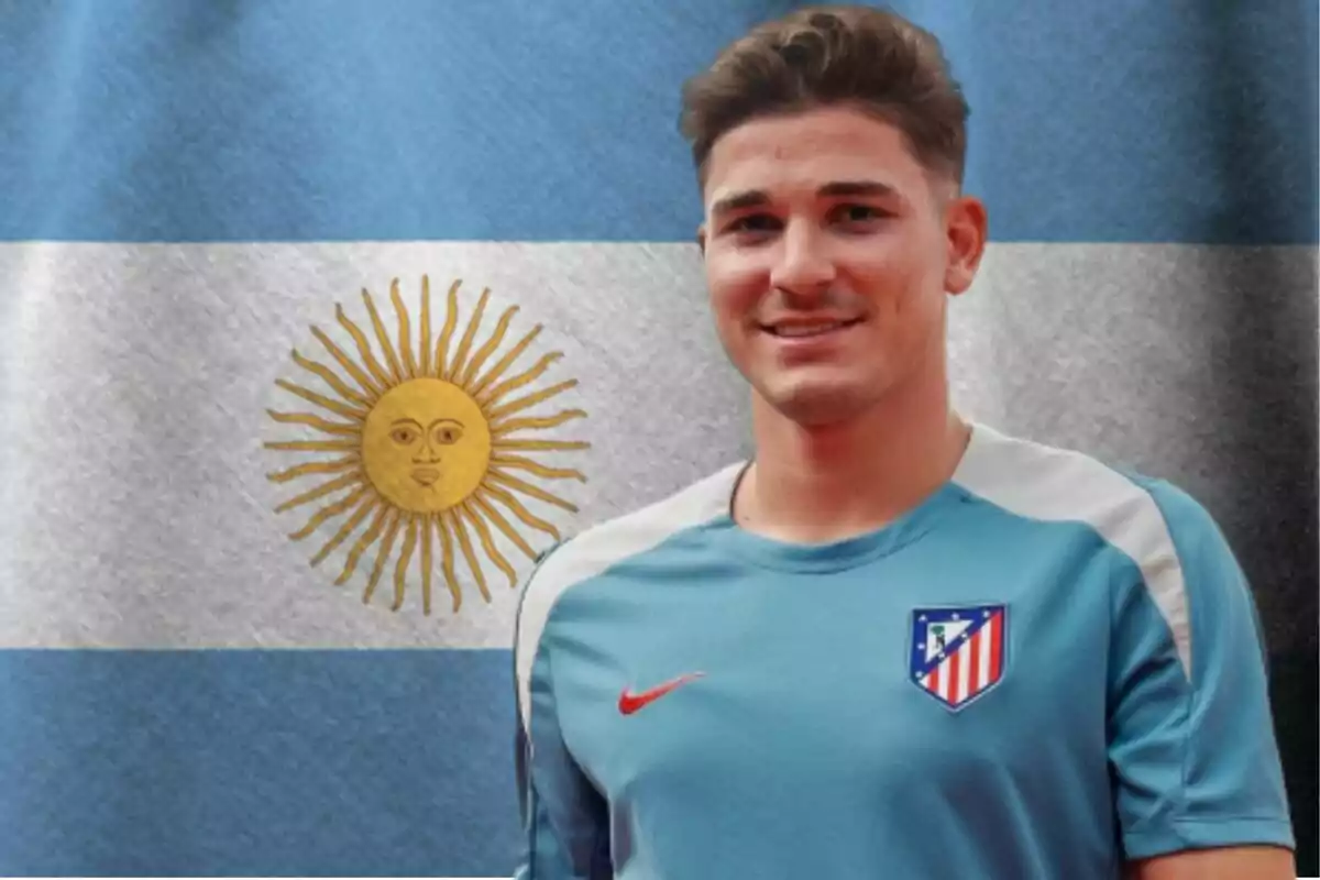 A young man wearing an Atletico Madrid training shirt stands in front of an Argentine flag.