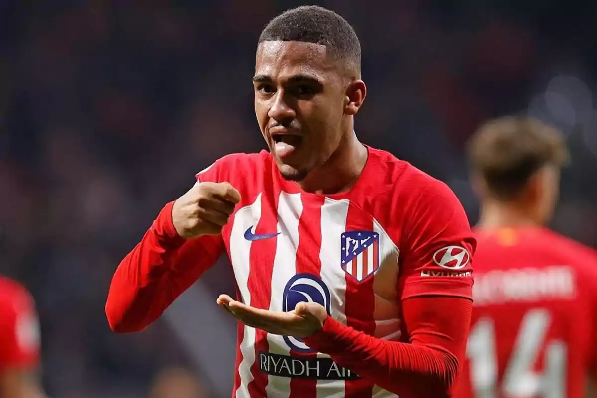 Atlético de Madrid soccer player celebrating a goal with a gesture on the field.