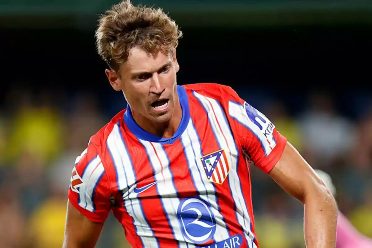 Football player wearing an Atlético de Madrid shirt in action during a match.