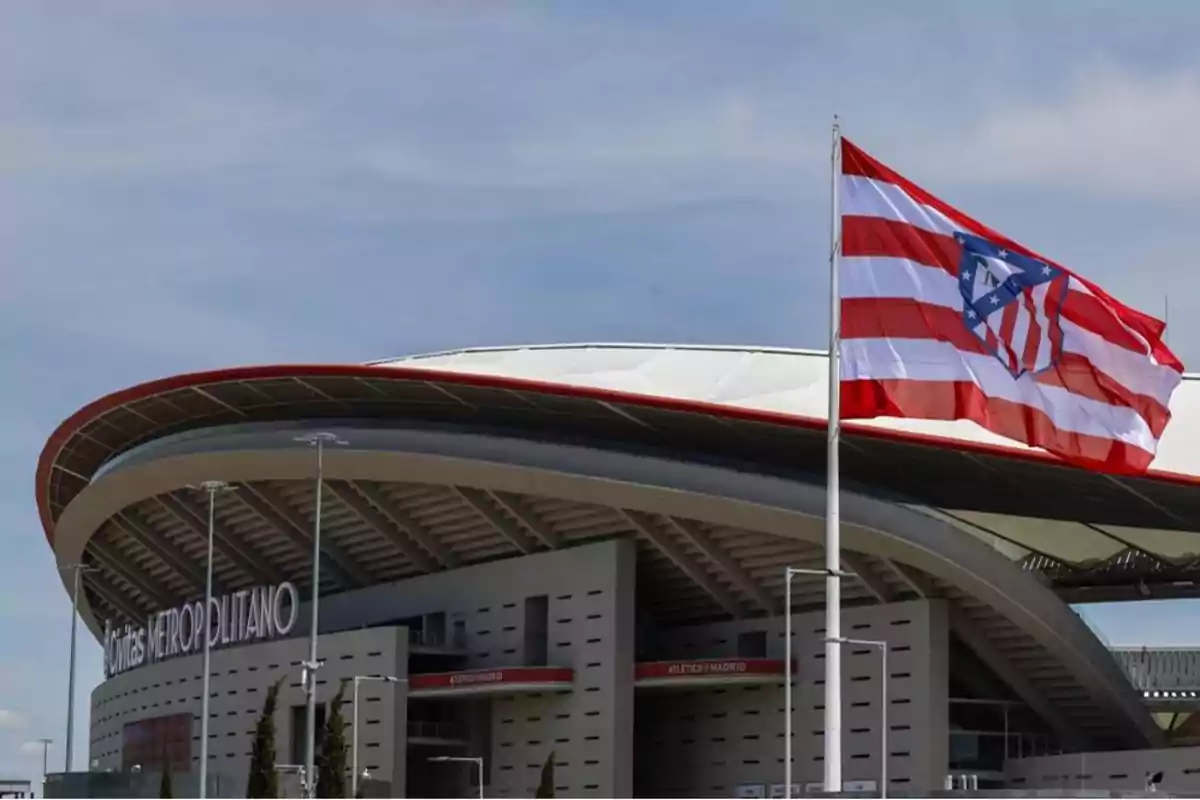 Civic Metropolitan Stadium with an Atletico Madrid flag waving in the foreground.