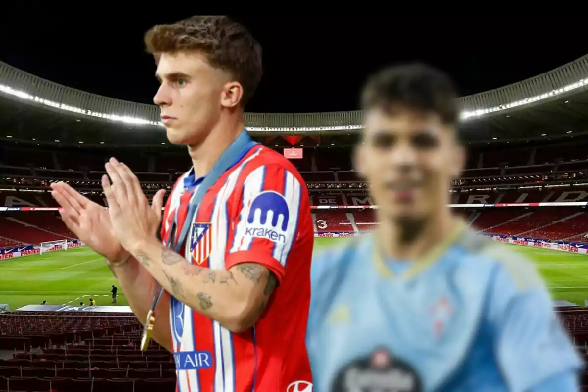 Two soccer players in a stadium, one in a red and white uniform applauding and the other in a light blue uniform out of focus in the foreground.