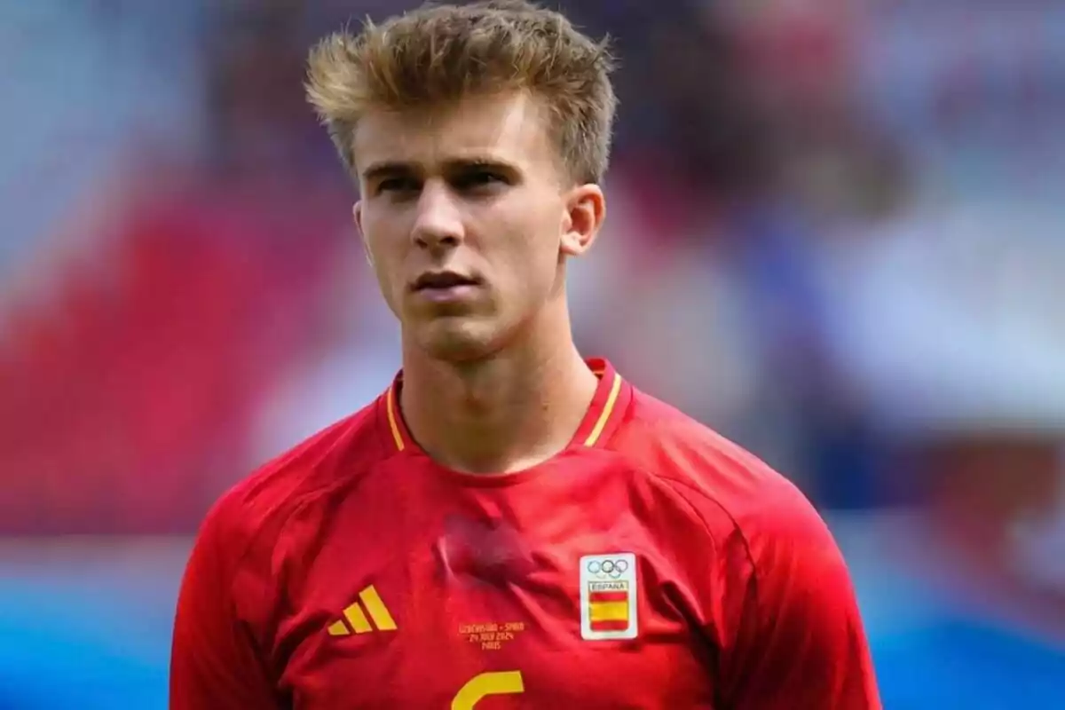 A soccer player wearing the red shirt of the Spanish national team.