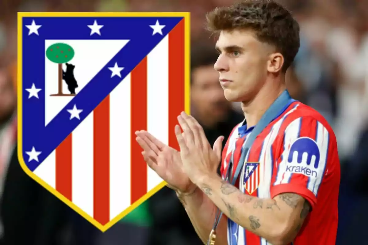 Atlético de Madrid player applauding with the team's crest in the background.