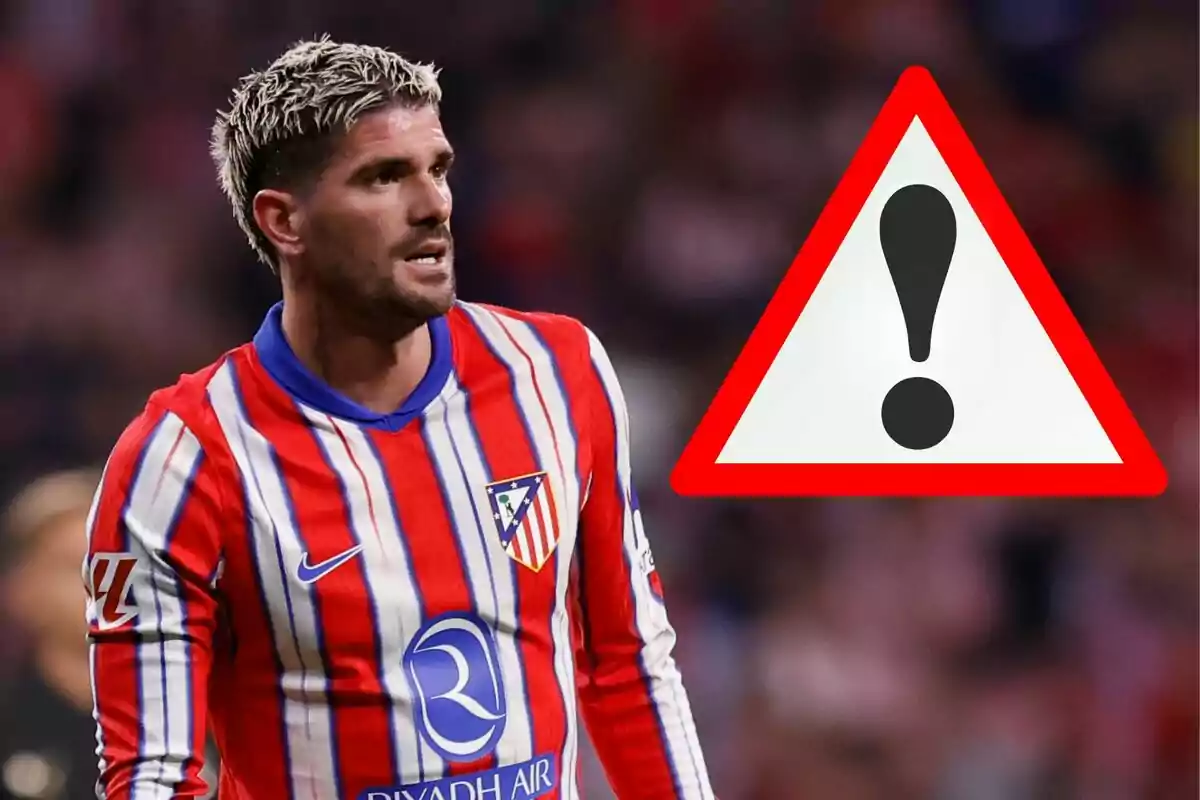 Atletico Madrid player with a warning sign.