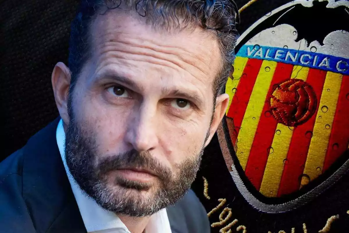 Rubén Baraja looking forward with a serious face and the Valencia CF shield in the background