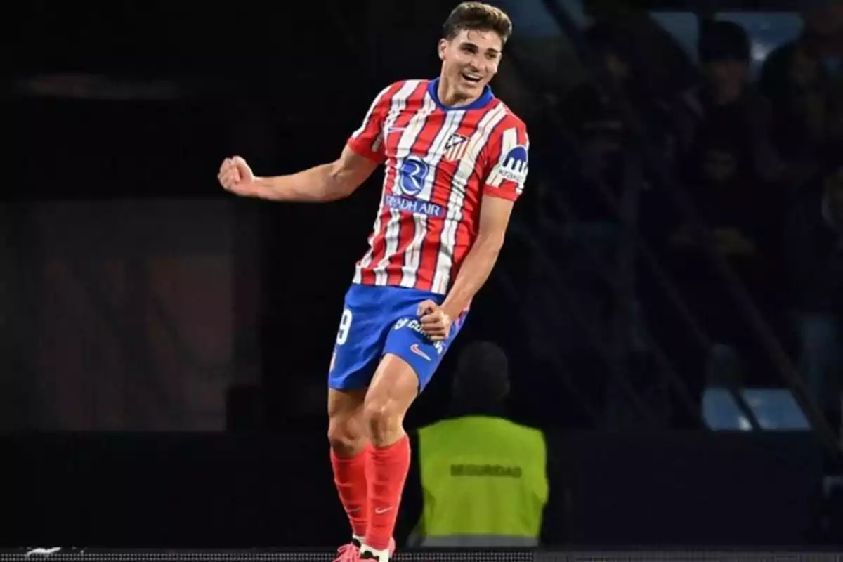 Football player celebrating a goal in the Atlético de Madrid uniform.