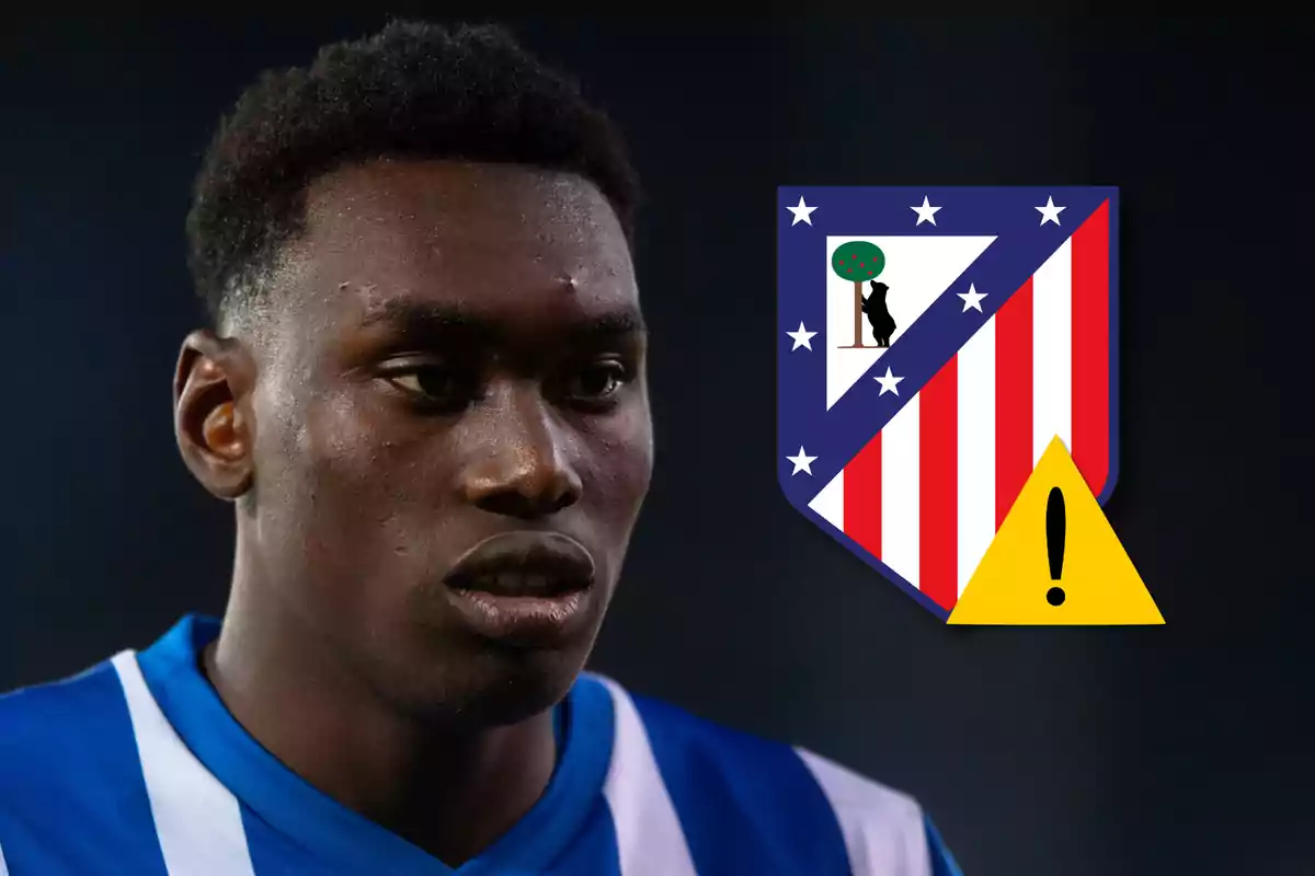 A soccer player in a blue and white uniform next to the Atlético de Madrid shield with a yellow warning sign.