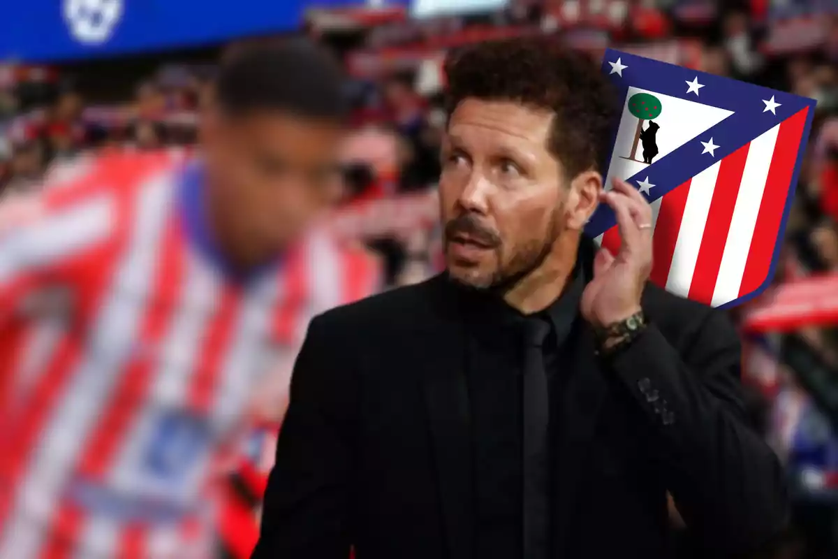 A man in a black suit and beard, with the Atlético de Madrid logo in the background, in a football stadium.