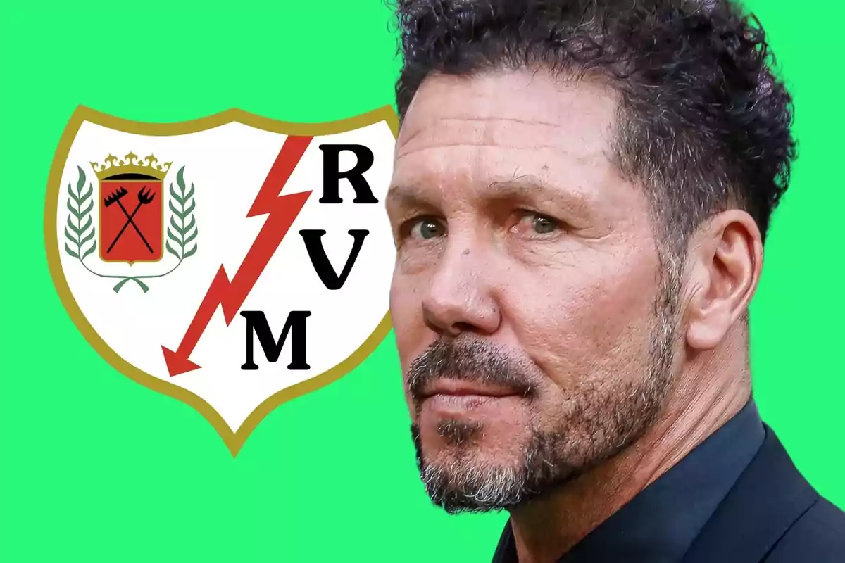 Man with a beard and curly hair in front of the Rayo Vallecano crest on a green background.